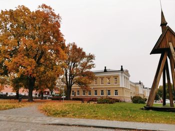 Trees and buildings against sky