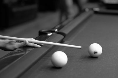 Cropped hand of person playing pool