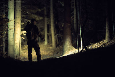 Rear view of man walking in forest