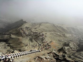 High angle view of people on mountain against sky
