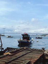 Sailboats moored on sea against sky