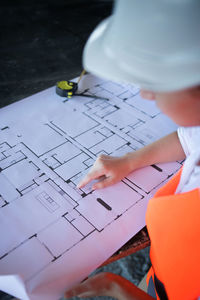 High angle view of woman working on blueprint