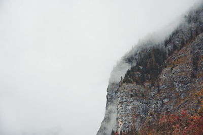 Low angle view of mountain against sky during winter