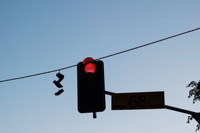 Low angle view of road sign against clear sky