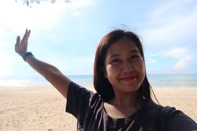 Portrait of smiling young woman on beach