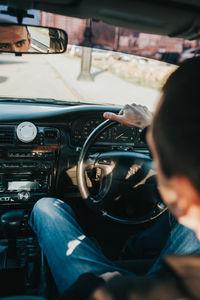 Rear view of man driving car