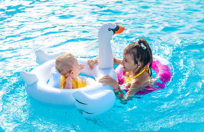 Cute sisters in swimming pool