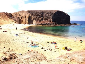 Group of people on rocks at beach