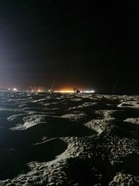 People standing at beach against sky