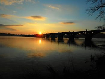 Scenic view of river at sunset