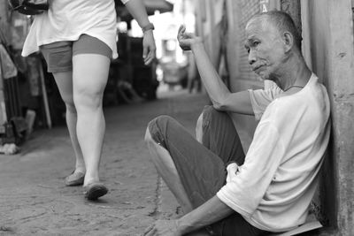 Close-up of woman standing on railing