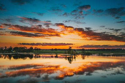 Scenic view of lake against romantic sky at sunset