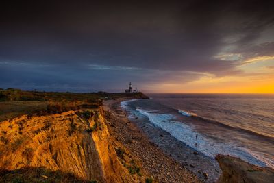 Scenic view of beach against sky during sunset