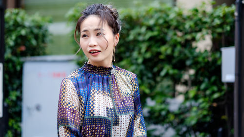 Portrait of smiling woman standing outdoors