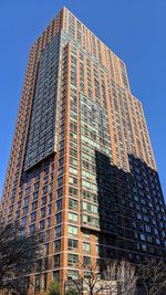 Low angle view of modern building against clear blue sky