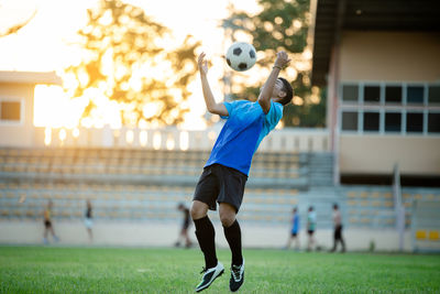 Man playing soccer ball on field