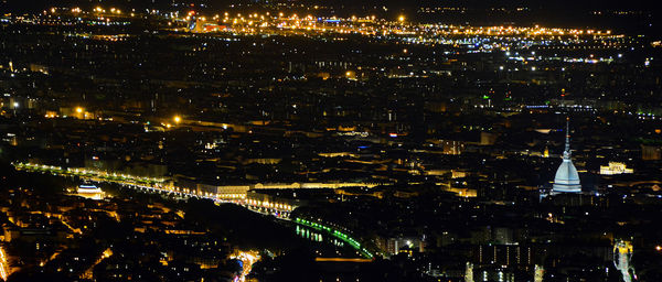 Illuminated city against sky at night