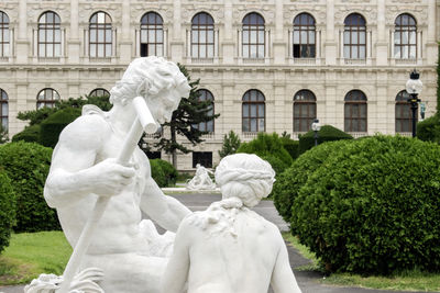 Statue against historic building