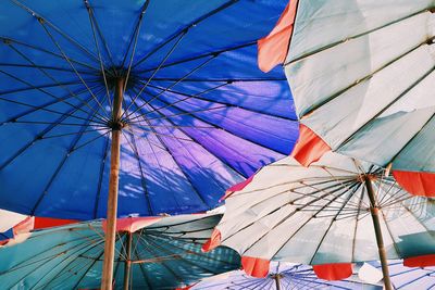 Low angle view of multi colored beach umbrellas