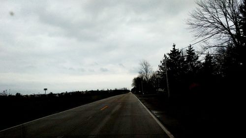 Road passing through bare trees