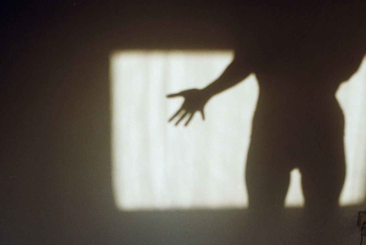 SHADOW OF PEOPLE ON WALL AT HOME