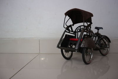 Bicycles on tiled floor against wall