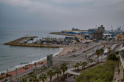 High angle view of buildings by sea against sky