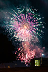 Low angle view of firework display at night