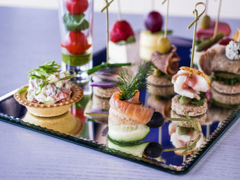 Close-up of various canapes and snacks served on table