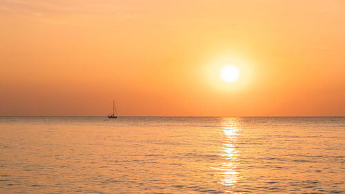 Scenic view of sea against orange sky during sunset