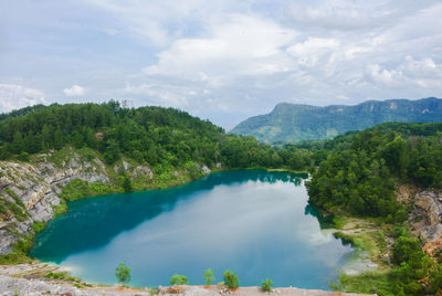 Scenic view of lake and mountains against sky