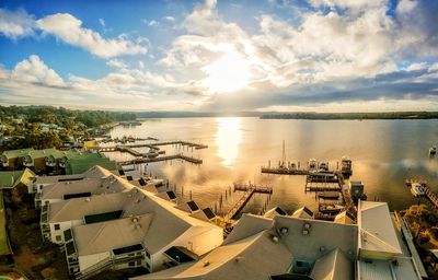 High angle view of sea and cityscape against sky