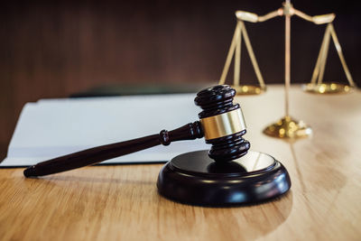 Close-up of gavel and weight scale on desk in courtroom