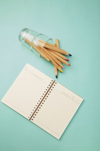 High angle view of book on table against blue background
