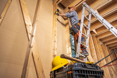 Low angle view of man working at construction site