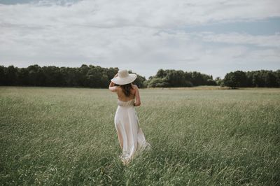 Woman walking on green field