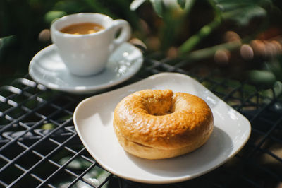 Close-up of homemade bagels and l coffee espresso on a gray chair natural background