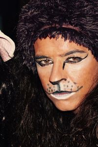 Close-up portrait of person in lion face paint