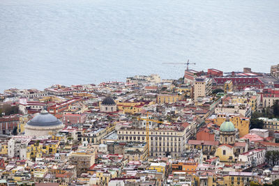 High angle view of townscape by sea