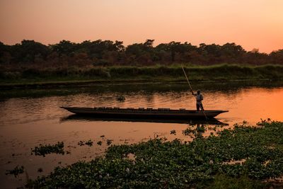 Boats in lake at sunset