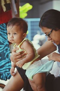 Mother checking son diaper