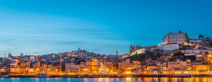 Illuminated buildings against blue sky