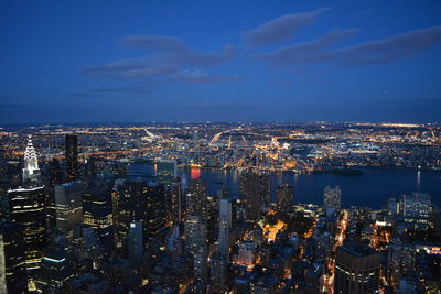 High angle view of city lit up at night