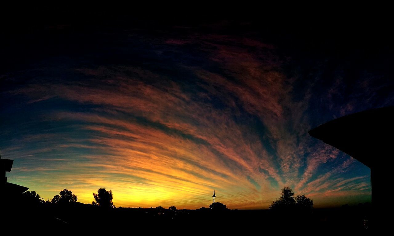 silhouette, sunset, sky, scenics, orange color, beauty in nature, cloud - sky, tranquility, tranquil scene, low angle view, dramatic sky, tree, nature, cloud, idyllic, dark, built structure, moody sky, outdoors, landscape