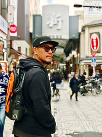 Side view of man standing on street