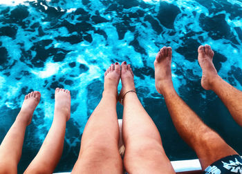 Low section of people against swimming pool