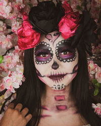 Close-up portrait of woman with pink flowers