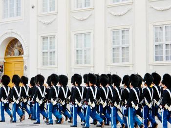 Honor guards marching against building