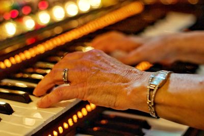 Close-up of hand playing piano