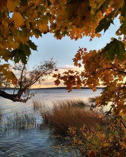 Scenic view of lake against sky at sunset